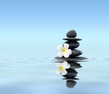 Zen spa concept background, Zen massage stones with frangipani plumeria flower in water reflection