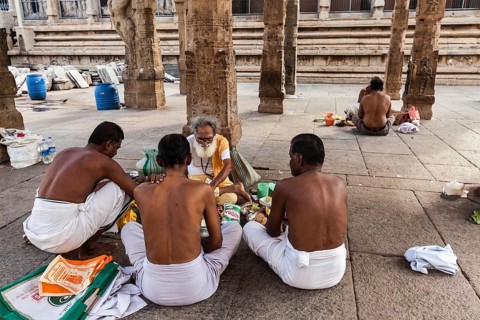 MADURAI, INDIA, FEBRUARY 16, 2013: Indian brahmin (traditional Hindu society) priest and pilgrims