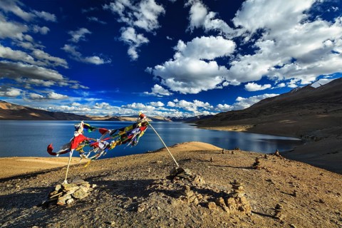 Buddhist prayer flags lungta at Himalayan lake Tso Moriri in Himalayas, Korzok, Ladakh, India, Asia