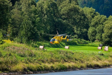 An ADAC rescue helicopter attempts to land on the banks of the Elbe in Schöna in Saxon Switzerland