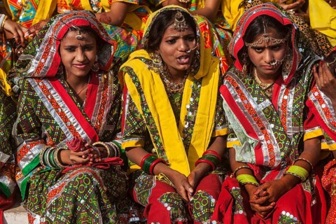 PUSHKAR, INDIA, NOVEMBER 21, 2012: Unidentified Rajasthani girls in traditional outfits prepare for