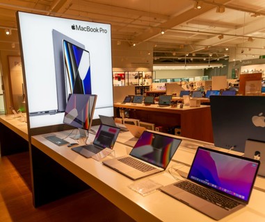 Apple MacBook Pro computers display in John Lewis at Home shop, Ipswich, Suffolk, England, UK