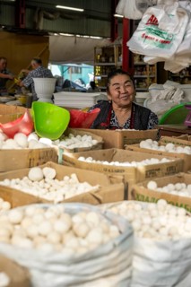 Traditional woman selling food, market stall at Osh Bazaar, Bishkek, Kyrgyzstan, Asia