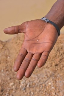 Hand of a diamond hunter displaying a diamond, near Koidu, Koidu-Sefadu, Kono District, Eastern