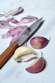 Fresh red garlic cloves with knife, France, Europe