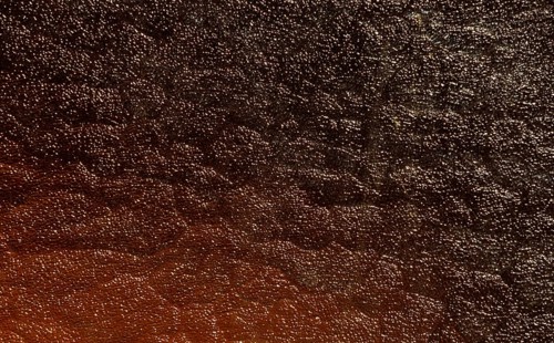 Light reflections on a pane of glass, abstract black and white orange background