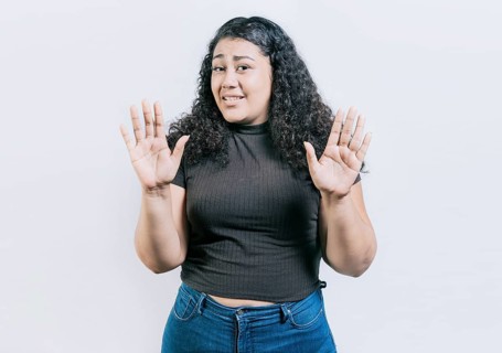 Woman with face disgusted raising hand isolated. Girl with disgust face isolated. Latin girl with