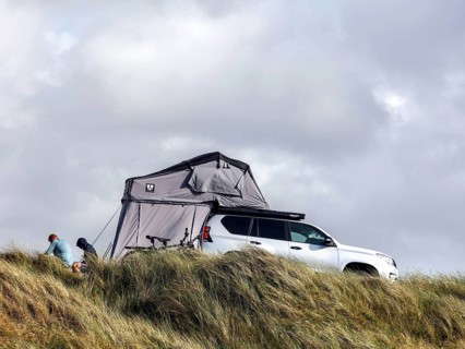 An SUV with awning stands in the dunes of a campsite, Vejers, Denmark, 16 07 2023, Europe