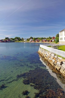 Bay with crystal clear water, some wooden buildings, Tjotta, FV 17, Kystriksveien, Helgeland,