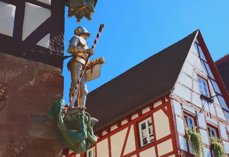 In the historic centre of Nuremberg, St. George as dragon slayer at Pilatus House (left) and houses