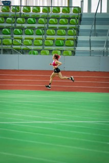 Only runner in an empty, large stadium, running track and green seats, Glaspalast, Sindelfingen