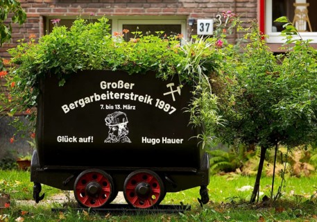 Coal lorry in the front garden commemorating the big miners' strike in 1997, Gelsenkirchen, Ruhr