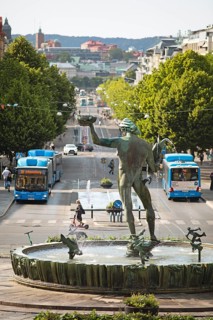 Poseidon statue, hybrid buses at the back in Kungsportsavenyen, Gothenburg, Västra Götalands län,