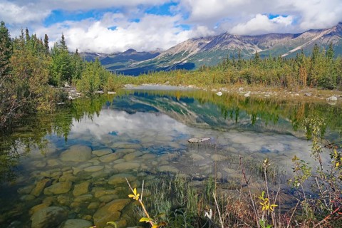 Crystal clear lake reflecting trees and mountains, autumn atmosphere, calendar picture, Copper