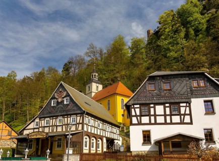 Half-timbered houses and small village church on a slope, Umgebindehäuser, Oybin, Zittau Mountains,