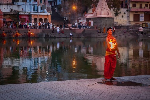 UJJAIN, INDIA, APRIL 23, 2011: Brahmin performing Aarti pooja ceremony on bank of holy river