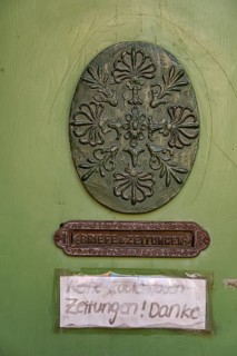 Oval carving and door slot with the inscription Letters & Newspapers as well as sign No free