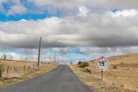Desolate road in the countryside on a sunny summer day. Cevennes, France, Europe