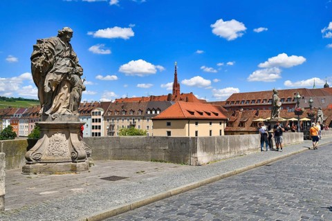 Würzburg, Germany, June 2022: Old Main bridge called ' Alte Mainbrücke' with saint sculpture,