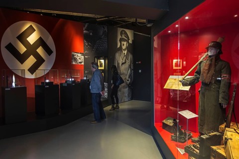 Tourists with audio guides visiting the Bastogne War Museum devoted to the Second World War Two