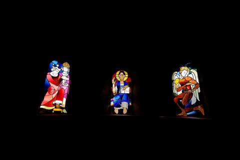 Three colourful church windows with figures in the Ulrich Chapel in the UNESCO Imperial Palace,