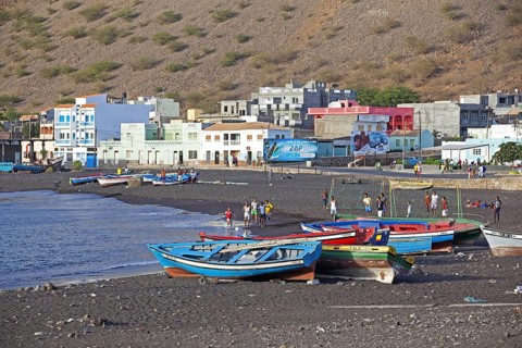 Colourful wooden fishing boats on the black sand beach of Tarrafal de São Nicolau on the island São