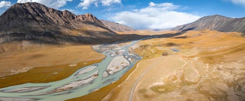 Aerial view, Burkhan mountain valley with meandering river, barren dramatic mountain landscape,