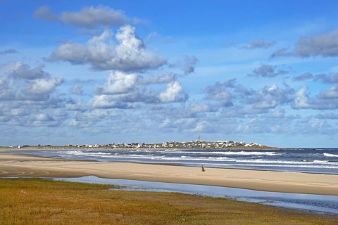View over the beach, lighthouse and village Cabo Polonio along the Atlantic Ocean coast, Rocha