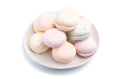 Colored zephyr or marshmallow isolated on white background. Side view, close up