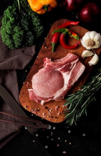 Raw pork meat, on a wooden board, close-up, vertical, no people, selective focus, rustic, serving,