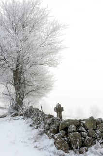 Aubrac plateau. Stone path cross in winter. Lozere department. Occitanie. France