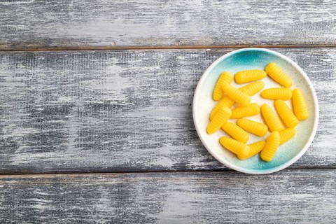 Jelly corn candies on gray wooden background. top view, flat lay, copy space
