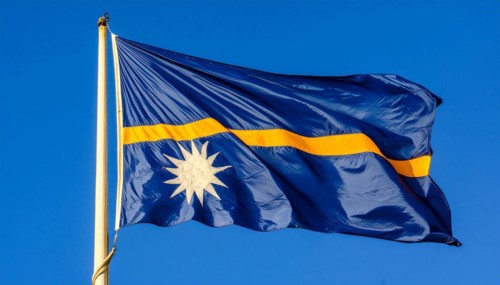 The flag of Nauru, an island nation in the Pacific Ocean, flutters in the wind, isolated against a