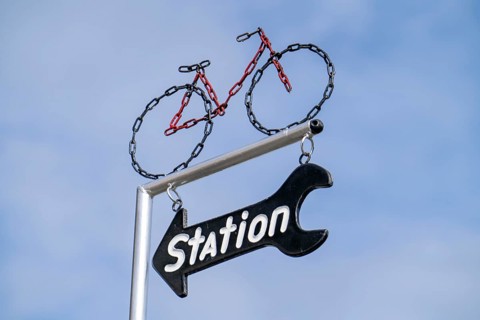 Advertising sign for a bicycle shop, service station