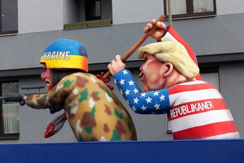 Donald Trump pierces a Ukrainian soldier with a spear, papier-mâché figure, satirical float by