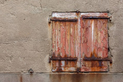 Window with dilapidated shutters and rusty iron fittings, Roscoff, Finistère, Brittany, France,