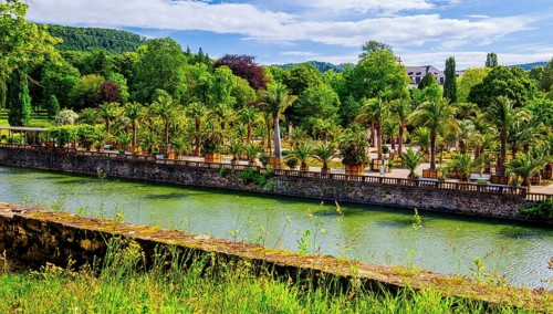 Castle moat with palm garden in the spa gardens, the largest outdoor palm garden north of the Alps,
