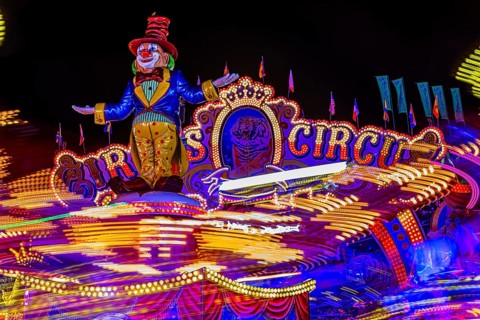 Illuminated round and elevated ride Circus Circus gondolas in motion, night shot, night shot