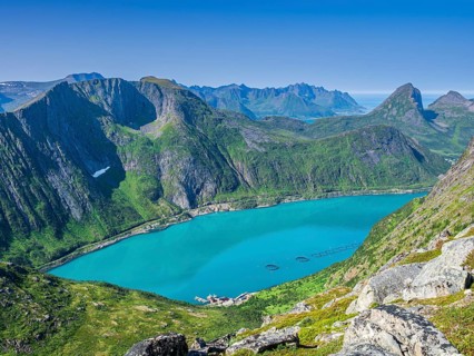View over fjord Örnfjord to mountain Segla (right), road to Fjordgard, cages of salmon farm in the
