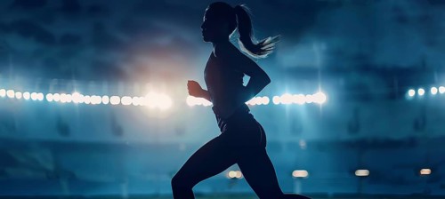 Determined young runner during a strenuous exercise running on a stadium on runner track, AI