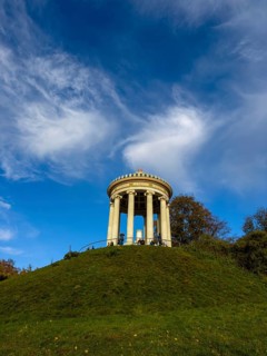 Monopteros with autumn atmosphere and dynamic cloud structure, English Garden, Munich, Bavaria,