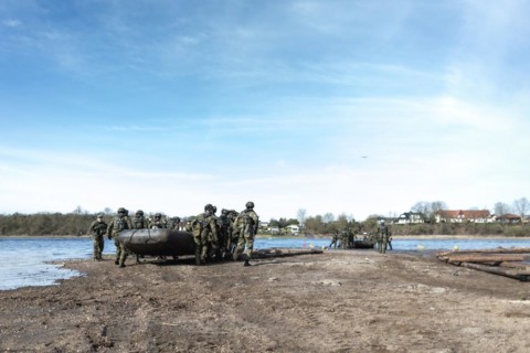 Czech soldiers launch an inflatable boat for a water crossing as part of the military exercise