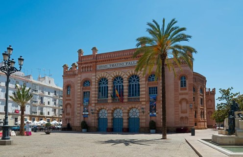 A red historic building on a town square with palm trees, Gran Teatro Falla, theatre, old town,