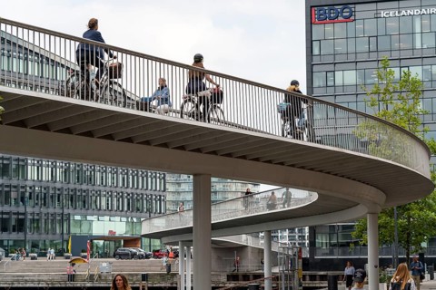 Cyclists on the Cykelslangen cycle and pedestrian bridge, at the Fisketorvet shopping centre,