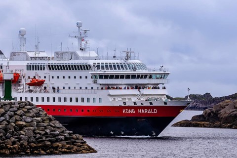 Ship 'Kong Harald' of Hurtigruten company is approaching harbor of Stamsund, island Vestvagøy,