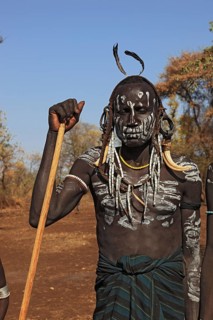 South Ethiopia, in Maco National Park, Mursi tribe, Mursi boy with painted face and headdress,