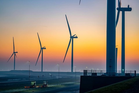 Lorry on the road from Euromax Terminal Rotterdam, ENECO wind farm on the dike around the port of
