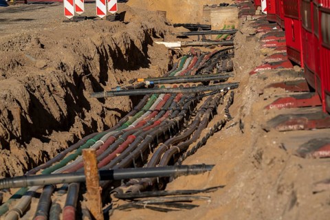 Cables, pipes, next to each other in a construction site, supply lines exposed during construction