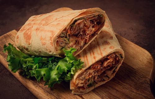Cut shawarma, 2 pieces, on a cutting board, close-up