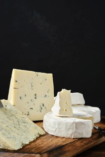 Closeup view of assortment of cheeses with blue mold